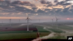 FILE - Wind turbines operate at an energy plant near Stetten, north of Kaiserslautern, Germany, as the sun rises March 19, 2024.