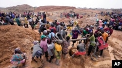 Miners work at an illegal tin mining site in Jos, Nigeria, April 3, 2024. 