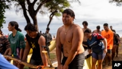 Morgan 'Bula' Montgomery helps bring a canoe in after practicing with the Napili Canoe Club, July 8, 2024, at Hanakao'o Park in Lahaina, Hawaii.