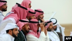 FILE - Saudi men look to spot the first crescent of the moon marking the start of the Muslim holy month of Ramadan, in Hautat Sudair, Saudi Arabia, March 10, 2024. The kingdom announced that Eid al-Fitr, which marks the end of Ramadan, will begin on Wednesday.