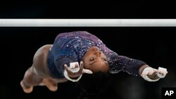 Simone Biles of the United States practices the uneven bars during a gymnastics training session at Bercy Arena at the 2024 Summer Olympics, July 25, 2024, in Paris.