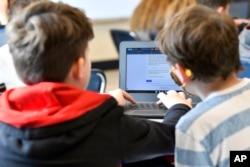 Michael Burton-Straub, left, and Declan Lewis attempt to "Find the Bot" in Donnie Piercey's class at Stonewall Elementary in Lexington, Ky., Monday, Feb. 6, 2023.