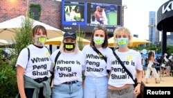 FILE - Spectators wear T-shirts reading "Where is Peng Shuai?" to the women's singles final at the Australian Open on Jan. 29, 2022.