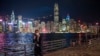 FILE - A man walks within view of the Hong Kong skyline, Oct. 19, 2022. China's economy has been struggling to recover from COVID-19 pandemic lockdowns and restrictions that wreaked havoc on trade and sparked public protests against the government.