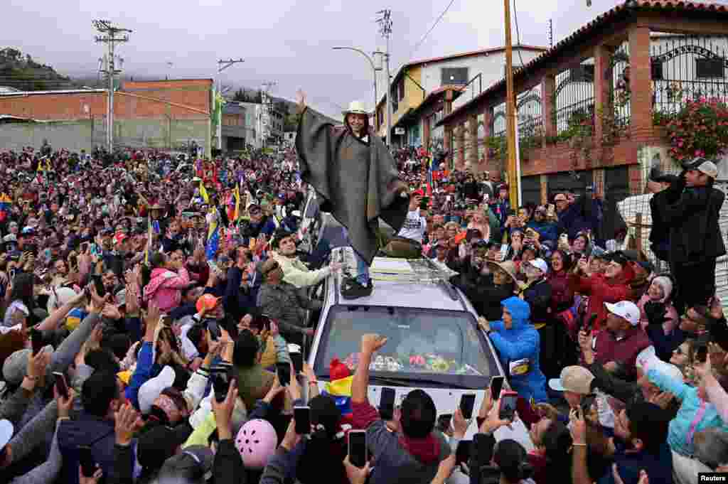 Venezuelan opposition leader Maria Corina Machado wears a traditional garment gifted by her followers as she tours the country despite not being able to run in the upcoming presidential elections, in Merida state, June 25, 2024. 