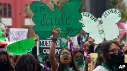 FILE - A woman holds up a sign with a message that reads in Spanish "I will decide" as she joins marchers demanding abortion rights, in Mexico City, Sept. 28, 2022. Mexico’s Supreme Court on Sept. 6, 2023, decriminalized abortion nationwide.