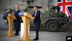 Britain's Prime Minister Rishi Sunak, right, and NATO Secretary General Jens Stoltenberg address a press conference at the Warsaw Armoured Brigade in Warsaw, Poland, April 23, 2024.