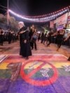 FILE - Shiite Muslims self-flagellate over an unfurled banner depicting the pride rainbow flag defaced with a boot and the Arabic words "no to a homosexual society," in Nasiriyah in Iraq's southern Dhi Qar province, July 25, 2023.
