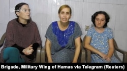 Israeli women identified by Israeli Prime Minister Benjamin Netanyahu as Yelena Trupanob, Danielle Aloni and Rimon Kirsht, who are held captive by Hamas in Gaza, give a statement in this handout video grab obtained by Reuters, Oct. 30, 2023.