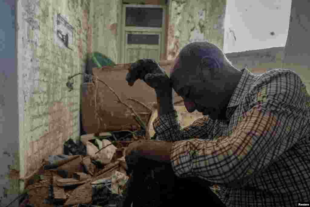 Hassan Kassar, 69, who said he lost his daughters, two of his sons and his granddaughter when a deadly storm hit the city, sits inside his damaged house, in Derna, Libya, Sept. 17, 2023.&nbsp;Some 11,300 people died when two dams collapsed during Mediterranean storm Daniel, sending a wall of water gushing through the city, according to the Red Crescent aid group.