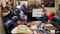 People in Idabel, Okla., call for the resignation of several McCurtain County officials at a county commissioners meeting April 17, 2023, after tapes with the officials' racist comments surfaced. (Christopher Bryan/Southwest Ledger via AP)