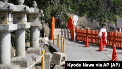 Stone lanterns fall at a shrine following a strong earthquake in Nichinan, Miyazaki prefecture, southern Japan, on Aug. 9, 2024. (Kyodo News via AP)