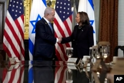 Vice President Kamala Harris shakes hands with Israeli Prime Minister Benjamin Netanyahu before a meeting in the Eisenhower Executive Office Building of the White House complex in Washington, July 25, 2024.