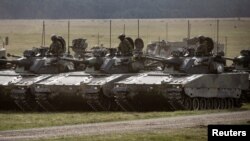 CV90 combat vehicles are seen during the Aurora 23 military exercise at Rinkaby firing range outside Kristianstad, Sweden, May 06, 2023. (TT News Agency/Johan Nilsson via Reuters)
