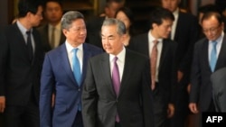 Chinese Foreign Minister Wang Yi (C) arrives at a diplomatic symposium at the Diaoyutai State Guesthouse in Beijing, Oct. 24, 2023. Wang arrived in Washington on Oct. 26 for meetings with senior U.S. officials on bilateral and regional security issues.