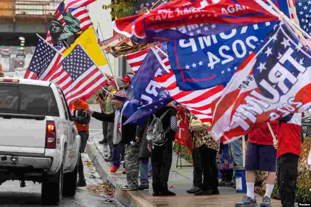 Supporters of former U.S. President Donald Trump gather for a loyalty rally at a busy intersection in Laguna Hills, California, March 21, 2023.