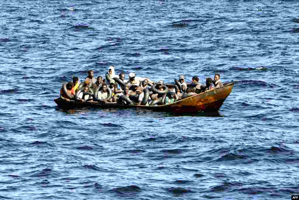 Мигранти од африканско потекло набиени на мал брод додека туниската крајбрежна стража се подготвува да ги пренесе на нивниот брод додека се на море, меѓу Тунис и Италија.
