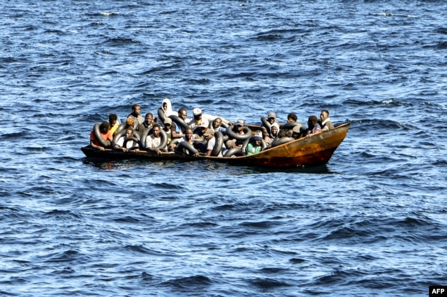 FILE - Migrants of African origin are crammed on board a small boat as the Tunisian coast guard prepares to transfer them onto its vessel, at sea between Tunisia and Italy, on Aug. 10, 2023. Most of the 261,000 migrants who entered Europe illegally in 2023 came to Italy.