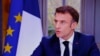 Presiden Prancis Emmanuel Macron terlihat di layar televisi selama wawancara dari Istana Elysee, di Paris, 22 Maret 2023.