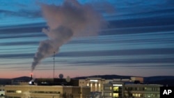 In this file photo, a plume of smoke being emitted into the air is seen from a power plant, Feb. 16, 2022, in Fairbanks, Alaska. (AP Photo/Mark Thiessen, File)