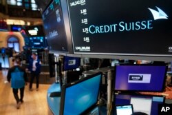 A sign displays the name of Credit Suisse on the floor at the New York Stock Exchange in New York, Wednesday, March 15, 2023.