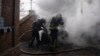 Rescue workers put out the fire of a car which was shelled by Russian forces at the residential neighbourhood in Kostiantynivka, Ukraine, Friday, March 10, 2023.