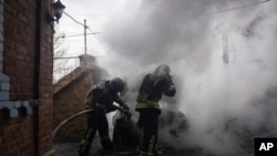 Rescue workers put out the fire of a car which was shelled by Russian forces at the residential neighbourhood in Kostiantynivka, Ukraine, Friday, March 10, 2023.