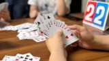 FILE - Finance professionals learn how to play guandan, a poker-like card game, during a training session in Beijing, China, August 6, 2023. (REUTERS/Yew Lun Tian)