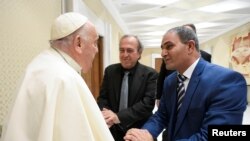 Pope Francis meets Bassam Aramin and Rami Elhanan, each of whom lost a daughter in the Israeli-Palestinian conflict, in Vatican City, March 27, 2024. (Vatican Media/Handout via Reuters)