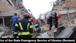 烏克蘭救援人員在基輔被俄羅斯無人機炸毀的建築中尋找生還者。（2023年3月22日）