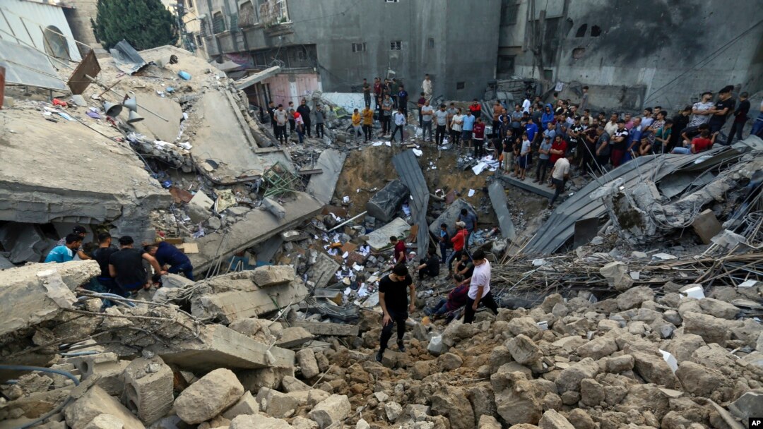 Palestinians inspect the site where there was a nearly 900-year-old Greek Orthodox church, destroyed following Israeli airstrikes on Gaza City, Oct. 20, 2023.