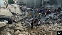 Palestinians inspect the site where there was a nearly 900-year-old Greek Orthodox church, destroyed following Israeli airstrikes on Gaza City, Oct. 20, 2023.