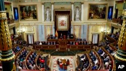 Spain's King Felipe VI, center, gives a speech during the new opening session of the Spanish parliament in Madrid, Nov. 29, 2023. Miguel Angel Oliver Fernández nominated to head the state-run EFE is due to appear before a parliamentary commission on Dec. 21, 2023.