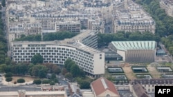 FILE - A photograph taken from the top of the Eiffel Tower shows an aerial view of Paris, with the UNESCO headquarters building, July 15, 2020.