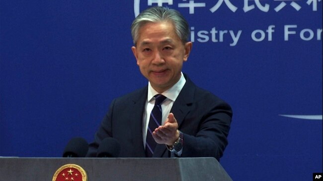 In this image from video, Chinese Foreign Ministry spokesperson Wang Wenbin gestures as he speaks during a media briefing at the ministry in Beijing, Feb. 13, 2023.