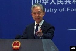 FILE - In this image from video, Chinese Foreign Ministry spokesperson Wang Wenbin gestures as he speaks during a media briefing at the ministry in Beijing, Feb. 13, 2023.