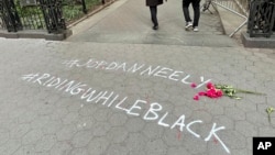 FILE - Hashtags scrawled onto a New York walkway draw attention to the death of Jordan Neely, May 5, 2023.