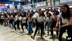 FILE - College students dance to various songs depicting different cultures of India as they conduct a flash mob to celebrate the country’s cultural diversity in Mumbai, India, Thursday, Sept.22, 2022.