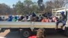 Arrested Zimbabwe election monitors, crammed into an open truck, arrive at Harare Magistrates Court, Aug. 25, 2023. (Columbus Mavhunga/VOA)