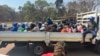 Arrested Zimbabwe election monitors, crammed into an open truck, arrive at Harare Magistrates Court, Aug. 25, 2023. (Columbus Mavhunga/VOA)