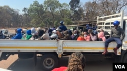 Arrested Zimbabwe election monitors, crammed into an open truck, arrive at Harare Magistrates Court, Aug. 25, 2023. (Columbus Mavhunga/VOA)