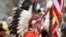 Blas Preciado, the vice commander of the Kiowa Blackleggings Warrior Society, takes part in the dedication of the National Native American Veterans Memorial on Friday, Nov. 11, 2022 in Washington.