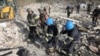 In this photo provided by the Ukrainian Presidential Press Office, emergency workers search the victims of the deadly Russian rocket attack that killed more than 40 people in the village of Hroza near Kharkiv, Ukraine, Oct. 5, 2023. 