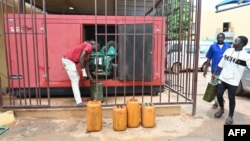 Diesel jerrycans are brought to a generator in Niamey, Niger, on Aug. 7, 2023. Nigeria announced on Aug. 2, 2023 that it was cutting off electricity supplies to its neighbor, in line with the sanctions decided by Niger's West African neighbors. 