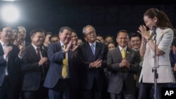 Thailand's Prime Minister-designate Paetongtarn Shinawatra, right, gestures to members of Pheu Thai party as she talks to reporters during a press conference at Pheu Thai party headquarters in Bangkok, Thailand, Aug. 16, 2024.