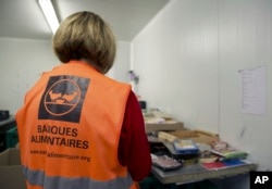 A volunteer sorts goods for distribution, at Banque Alimentaire, Aug. 6, 2024, during the 2024 Summer Olympics, in Gennevilliers, France.