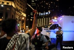 A protester reacts as police push back pro-Palestinian demonstrators after they attempted to stage a noise protest near the hotel where Democratic presidential candidate and U.S. Vice President Kamala Harris is staying in Chicago, August 22, 2024.