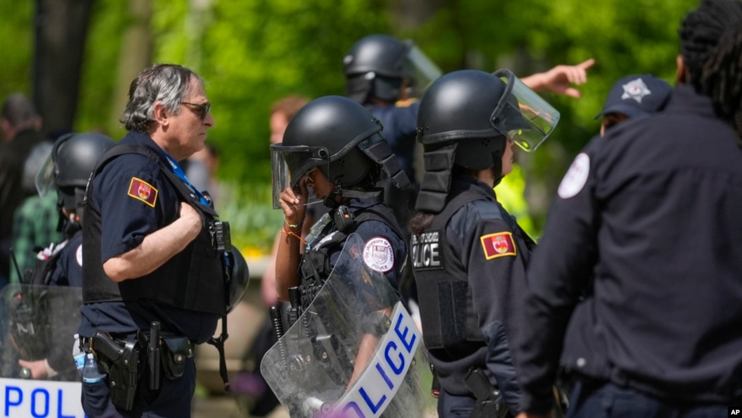 University of Chicago police stand between pro-Palestinian and pro-Israel protesters on the fifth day of a pro-Palestine encampment on campus, May 3, 2024, in Chicago. 