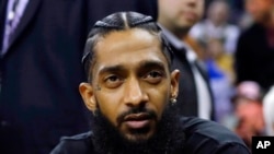 FILE - Rapper Nipsey Hussle attends an NBA basketball game in Oakland, Calif., March 29, 2018. 