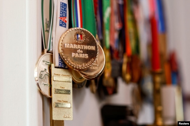 The medals of French runner Barbara Humbert, 83, long-distance world record winner who dreams to run the Olympic Marathon For All at the Paris 2024 Olympics and Paralympics Games, are pictured in her house in Eaubonne near Paris, France April 26, 2023. (REUTERS/Gonzalo Fuentes)